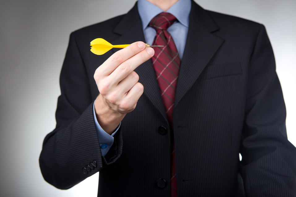 Businessman holding dart